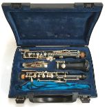 A Buffet Crampon oboe in carry case with spare reeds and a quantity of sheet music