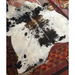 A large cow hide rug, approx. 230cmL