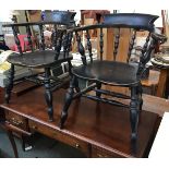 A good matched pair of 19th century ebonised smokers bow chairs, shaped collar above two-part bow,