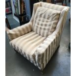 A modern Howard style armchair, upholstered in a striped fabric