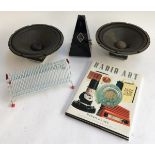 A mechanical metronome; together with a pair of 10" speaker cones; a CD rack and 'Robert Hall's