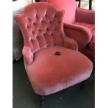 A small button back bedroom chair on casters