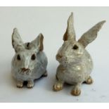 Two ceramic studio rabbits, one a piggy bank