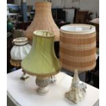 A set of four table lamps, one with wicker shade, several cast resin in the style of ivory