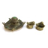 An Eastern brass inkwell set with malachite; together with two brass incense burners