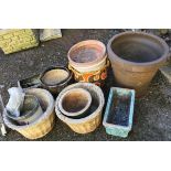 A mixed lot of garden planters, some glazed, some terracotta, a pair in the form of a wicker