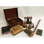 A mixed lot to include a number of pipes and pipe stand; small copper oil lamp; wooden sewing box;