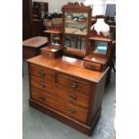 A dressing table with adjustable mirror, two pier drawers, over a chest of two short and two long