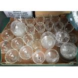 A selection of glasses to include four brandy balloons, champagne cups and a number of cut glass