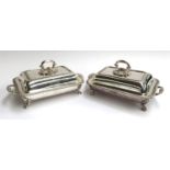 A good pair of plated chafing dishes, crested, with gadrooned edge, each on four scrolling feet,