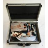 A small flight case containing a number of vintage gents photographs