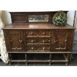 An early 20th century carved oak sideboard, on six turned legs, 153x55x97cmH
