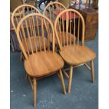 A set of four modern stick back kitchen chairs, on turned legs with H stretchers