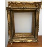 A carved giltwood and gesso picture frame in need of restoration, 80x64cm; together with two others