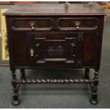 An early 20th century Charles II style oak sideboard, single drawer over cupboard door with barley