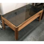 A mid century style smoked glass coffee table, 88x43.5x35cmH