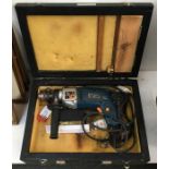 An AEG corded drill in wooden box