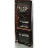 An Astragal glazed standing corner cupboard, with blind fretwork top, 183cmH