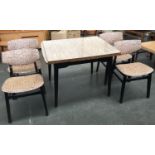 A 1950s Formica extending kitchen table, on dansette legs, with four matching chairs