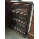 A three part sectional Globe-Wernicke style bookcase, with drawers belower, 87x27x114cmH