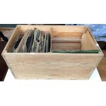 A vintage pine box containing a quantity of 78s
