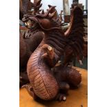 An Oriental carved hardwood dragon (af), 39cmH