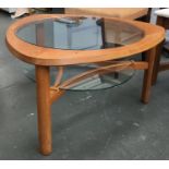A mid century tri-form coffee table, with circular glass inset top, glass undershelf, approx.