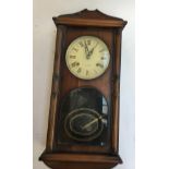 An oak cased wall clock, 31 day, roman numerals, 56cmH