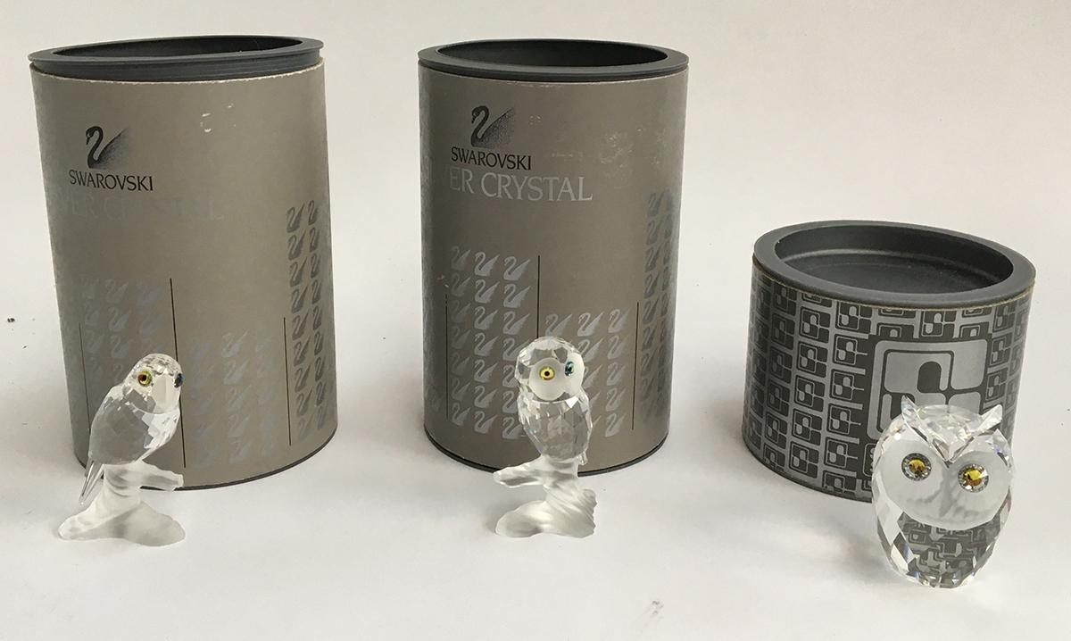 Three Swarovski crystal figurines, a parrot (7621), owl (7621), and one other owl, all boxed (3)