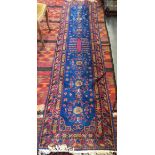 A West Persian blue ground runner rug, 305x72cm