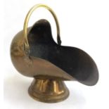 A brass helmet coal scuttle