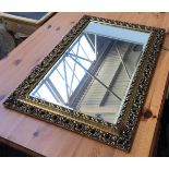 A scrolling gilt framed modern wall mirror, bevelled glass, 54x81cmH