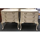 A pair of 1960s white painted bedside cabinets, each with three drawers on cabriole legs, 61cmW
