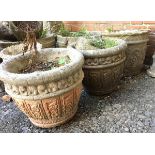 A pair of composite stone planters, 35cmD; together with one other and a garden gnome (4)