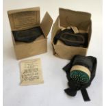 Two boxed WW2 gas masks, one with original literature; together with one other