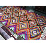 A very large brightly coloured flat weave rug, 295x175cm