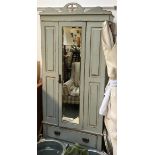 A 20th century hanging wardrobe, with distressed paint effect finish, single mirror cupboard door