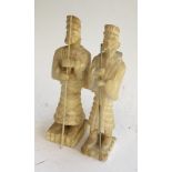 Two carved Persian figures with staves, 27cmH
