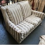 A Howard style contemporary two seater sofa, upholstered in a striped fabric, on tapered legs with