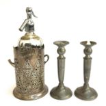 A vintage soda siphon, in a silver plated pierced wine cooler; together with a pair of pewter
