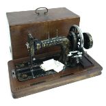 A Frister & Rossmann Berlin sewing machine in mahogany carry case, with key; together with one other