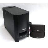 A Bose PS3-2-1 powered speaker system, comprising large subwoofer and two small speakers