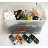 A large box of Scalextric to include a quantity of track, controllers, four cars, spare wheels etc