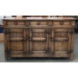 An early 20th century carved oak sideboard, three drawers of three cupboard doors, 153x43x91cmH