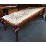 A long mahogany footstool with drop in upholstered seat, 125cmw