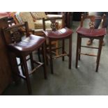 Three vinyl upholstered wheelback bar stools