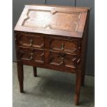 An early 20th century oak bureau, fall front over two sets of two drawers, on square section legs,