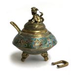 A Chinese brass and enamel lidded censer, one of the twin handles detached, on three feet, 17cmH