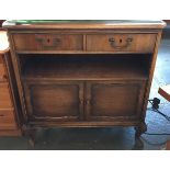 A mahogany bedside chest, with glass inset top above two drawers, undershelf and two cupboard