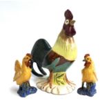 A pair of majolica cockerels, both 23cmH; together with a very large majolica cockerel, 48cmH